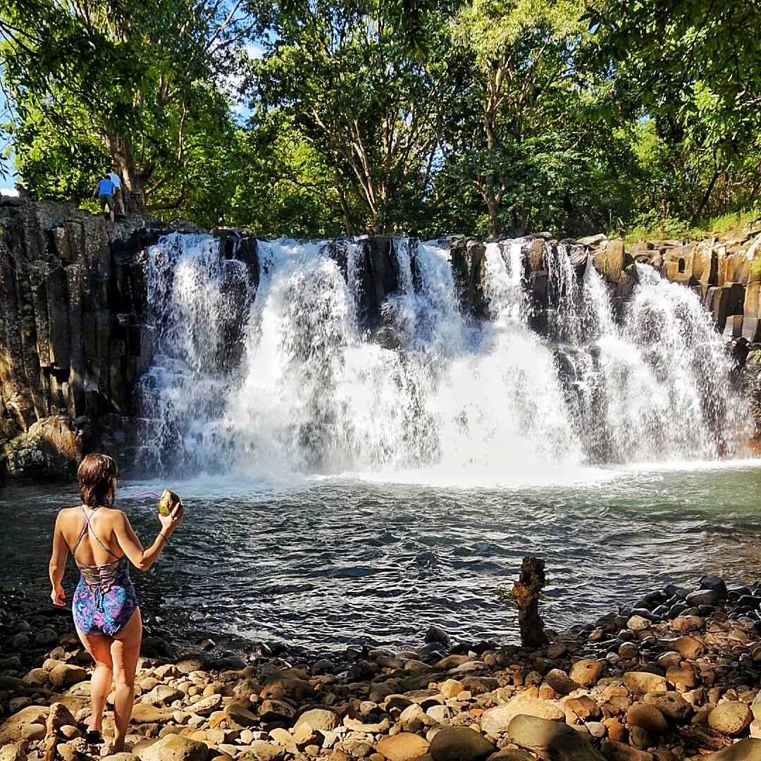 Admiring Rochester Falls with fresh coconut water