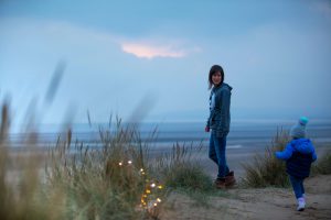An image of me standing admiring the views from the sand dunes on the beach at Camber Sands