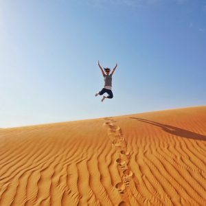 Me, mid air jump on top of a sand dune in Dubai Desert Conservation Reserve