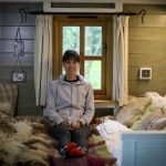 An image of myself sat on the bed in the shepherd's hut.
