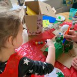 Emily painting our cardboard crocodile - things to do with kids during lockdown