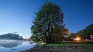 Camping by the lake at New Forest Water Park with a campfire